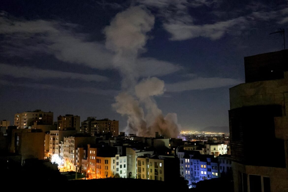 A smoke plume rises following a missile strike on a building in Tehran on March 1, 2026.